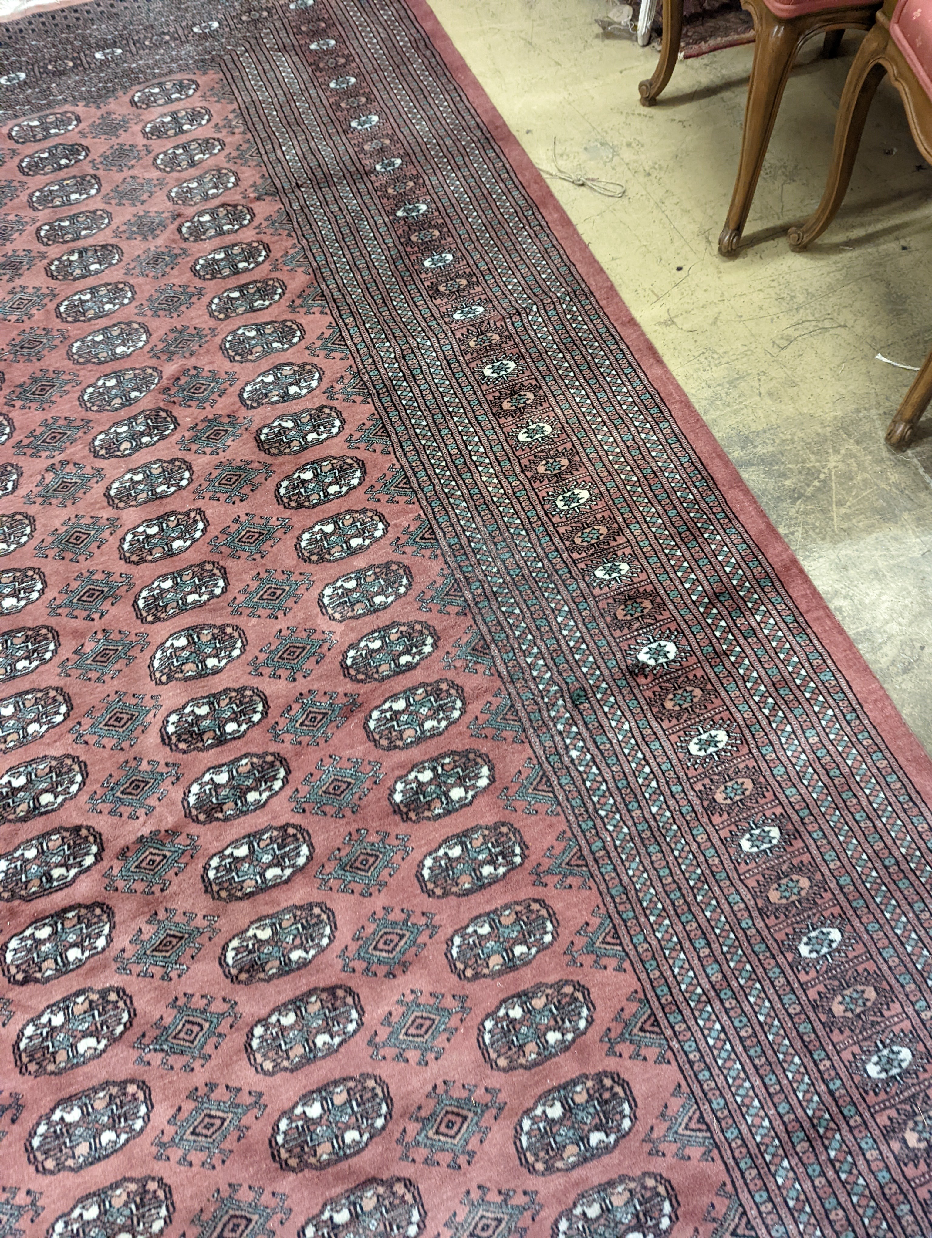 A pink ground Bokhara carpet, 315 x 220cm